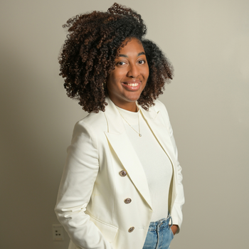 CourtneyeDrake2023 A black woman with natural hair wearing a cream top under a cream blazer