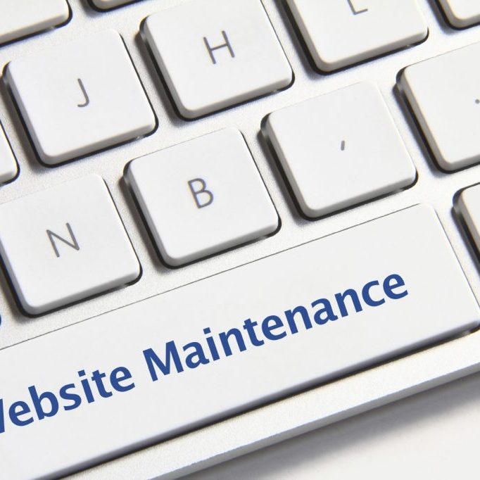 Website maintenance icon on white keyboard button