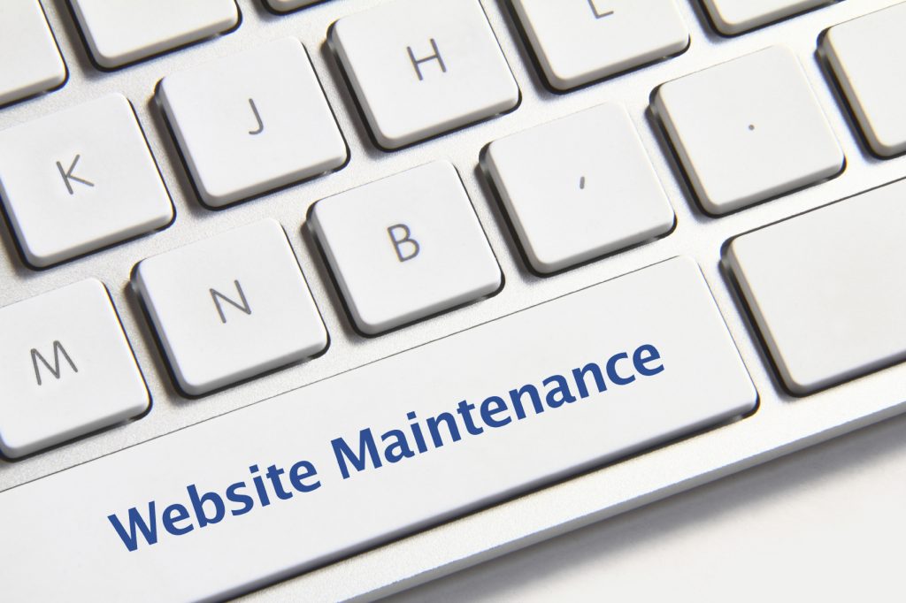Website maintenance button Website maintenance icon on white keyboard button